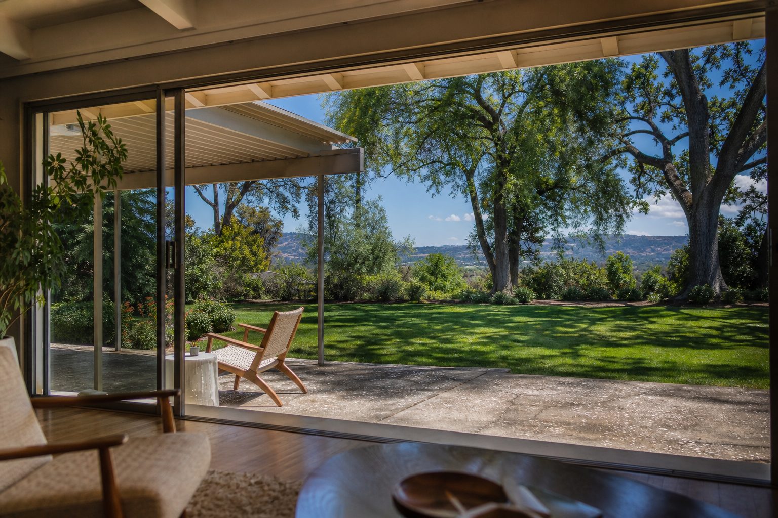 Covered patio opening to a landscaped backyard in a Woodland Hills home