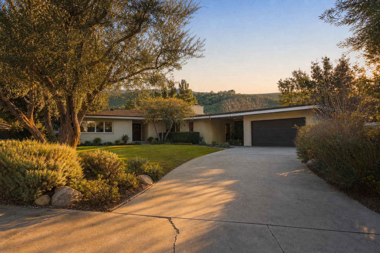 Mid-century ranch home with mature trees and wide driveway on a spacious Lake Balboa lot near the Sepulveda Basin.
