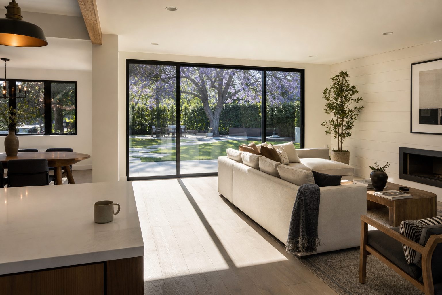 Remodeled Sherman Oaks home with open living space, natural light, and backyard views through large glass doors.