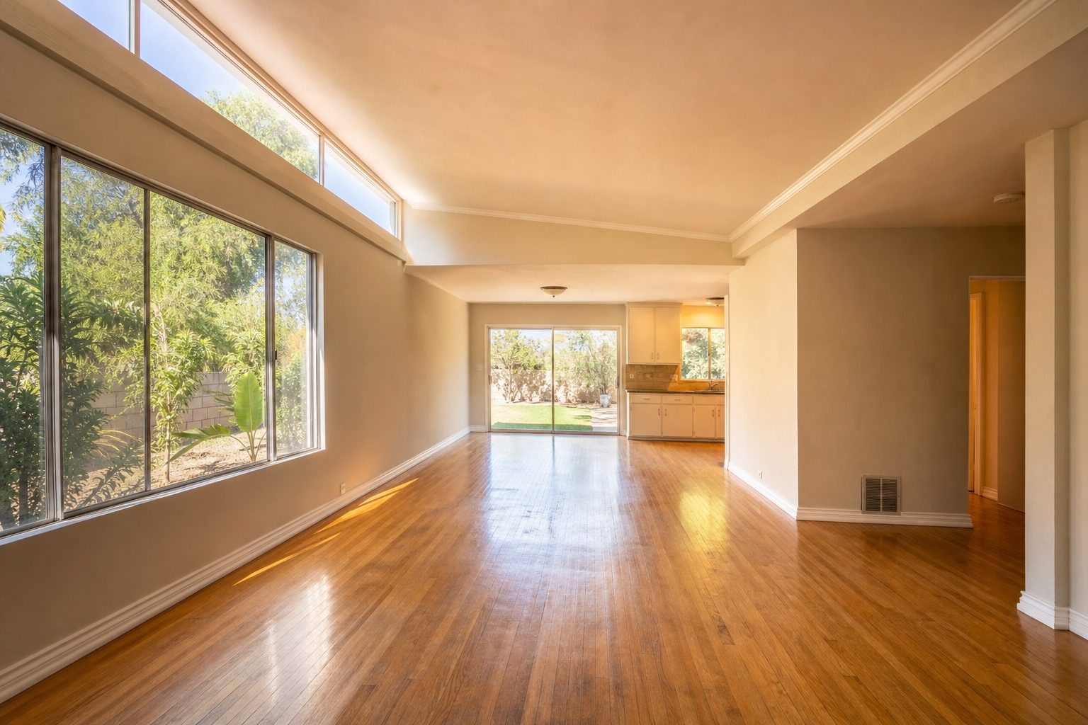Bright interior of 1950s ranch home showing original details, open floor plan, and natural light through windows.