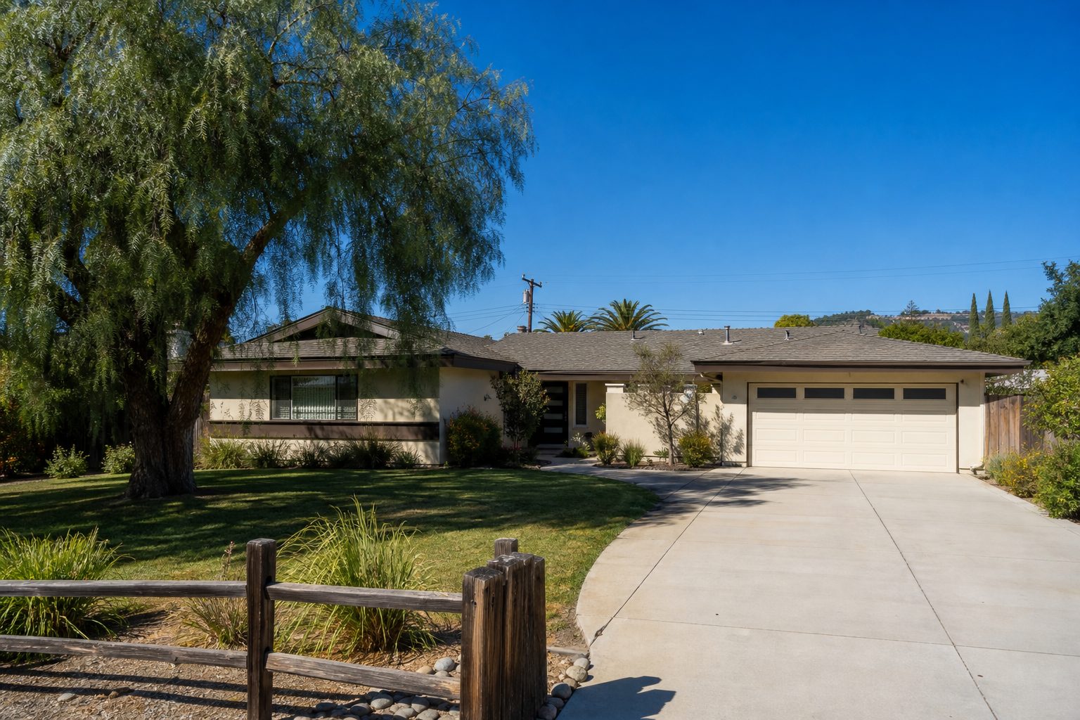 Single-story ranch home with mature pepper tree and drought-resistant landscaping on a flat North Woodland Hills property.